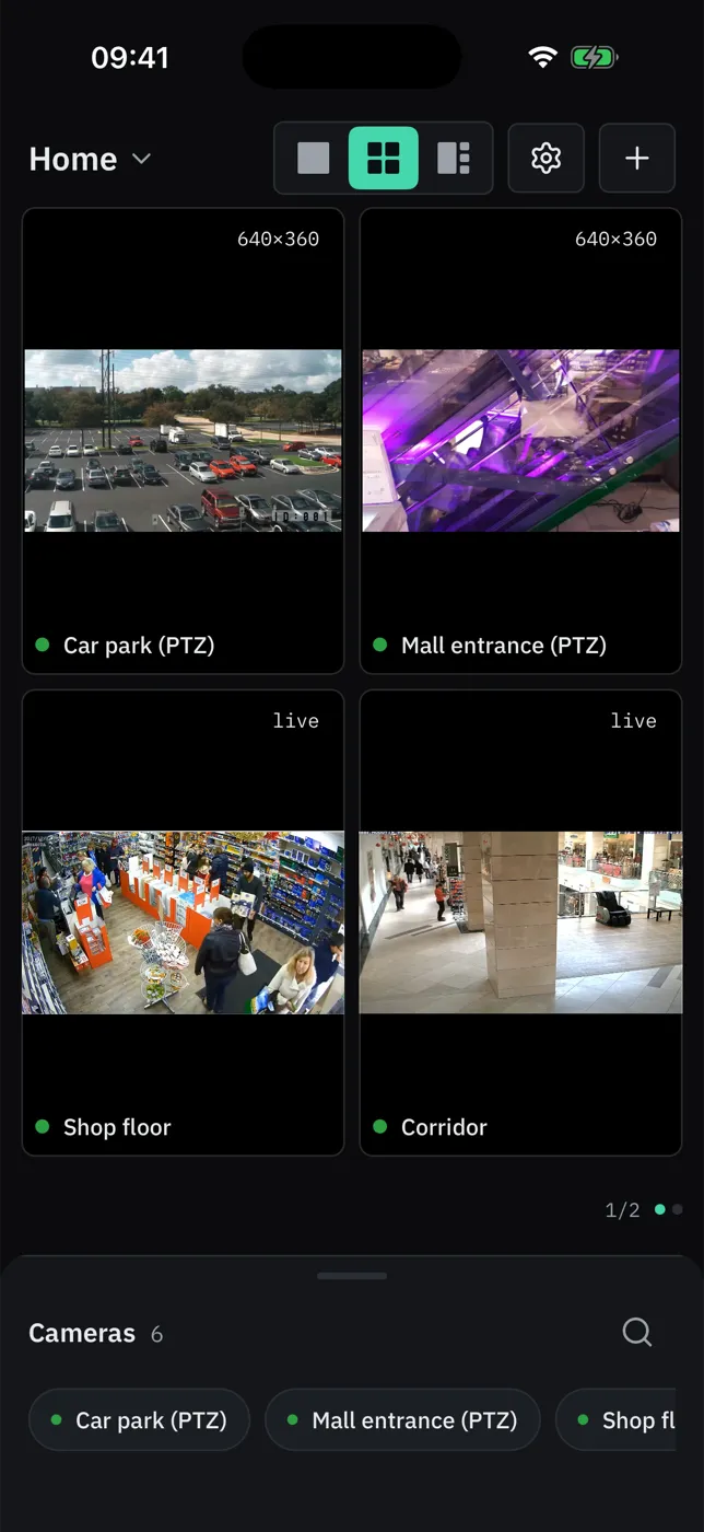 The same ViewTile wall on an iPhone, in the dark theme and in the light theme: four cameras in the 2×2 layout — a car park, a mall entrance, a shop floor and a corridor.